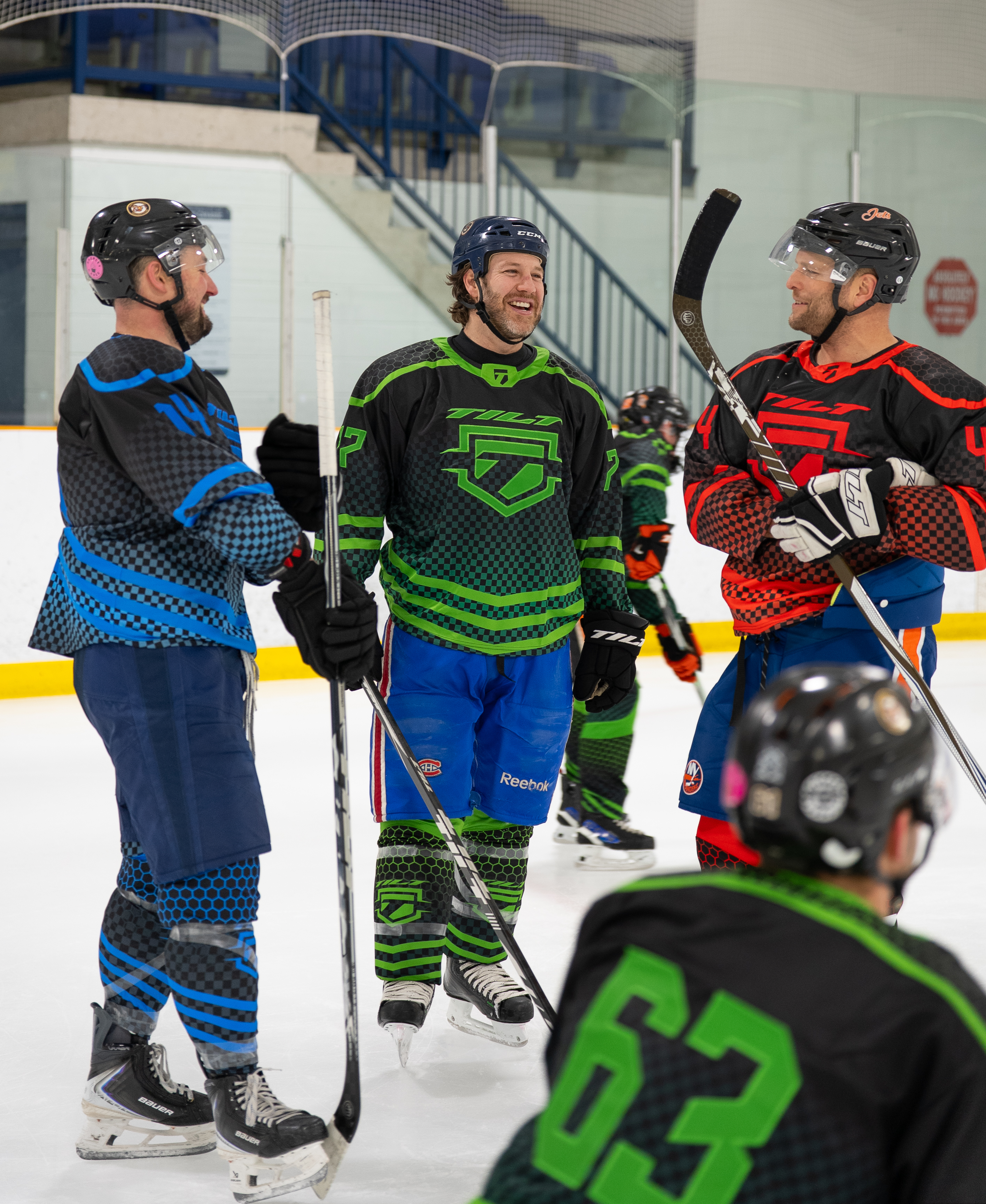 Tilt Hockey players laughing together on the ice